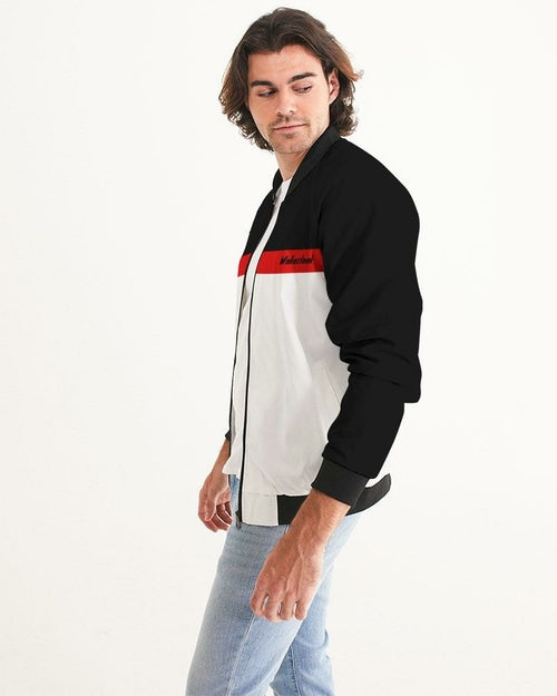 Men's bomber jacket in black and white with red stripe, relaxed fit, ribbed cuffs, and zip closure. Worn with light denim.