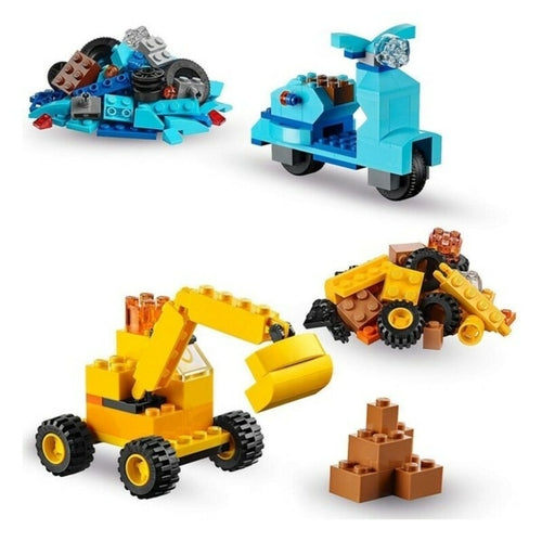 Colorful Lego bricks arranged into a blue scooter, yellow excavator, and various shapes, showcasing creative play possibilities.