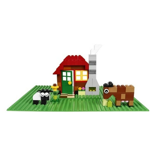 Colorful Lego brick set featuring a red house with a green door, chimney, sheep, and a brown horse on a green baseplate.