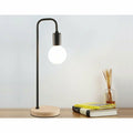 Contemporary black desk lamp with a natural wood base and gooseneck arm, showcasing a globe bulb.