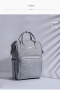 Gray quilted diaper bag backpack with dual zippers, adjustable padded straps, and a large front pocket.