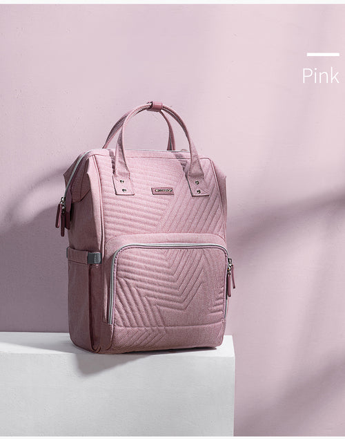 Pink Modern Quilted Diaper Bag Backpack with a geometric quilted pattern, featuring a front pocket and dual top handles.