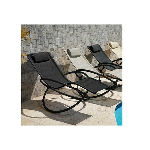 Black zero gravity rocking chair recliner with a smooth, curved frame, set against a stone wall near a pool.