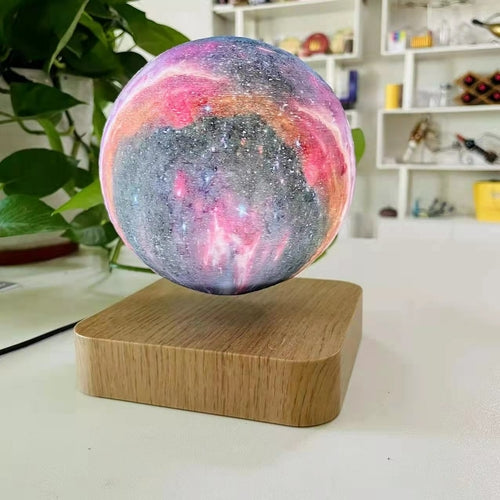 3D Print Moon Lamp in colorful galaxy pattern, levitating above a wooden base, showcasing vibrant reds, blues, and greens.
