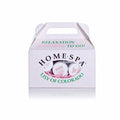 White box with a handle, labeled "HOME SPA" with green text, containing small jars visible inside, nestled in pink filler.