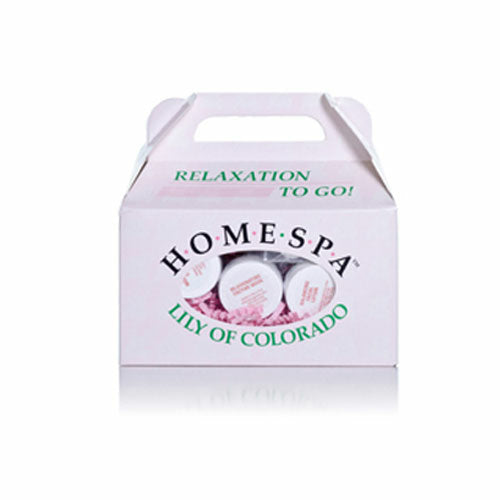 White box with a handle, labeled "HOME SPA" with green text, containing small jars visible inside, nestled in pink filler.