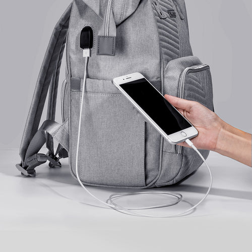 Gray Modern Quilted Diaper Bag Backpack with USB port, showcasing a smooth cable connection to a smartphone.