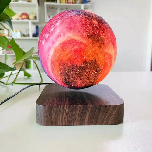 3D print moon lamp with vivid red and orange details, floating above a dark wooden base, creating a warm ambient glow.