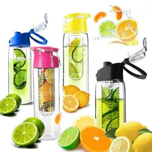 Four colorful Fruit Cola Bottles are displayed, each with a built-in fruit infuser tube. The bottles are filled with water and fruits, showcasing vibrant yellow, pink, blue, and black lids. Lemon and lime slices are arranged around the bottles.