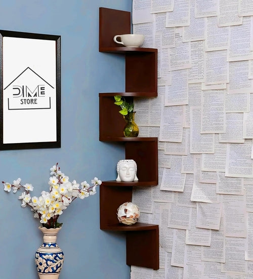 Stylish brown wall shelf arranged in a corner, displaying a vase, decorative head, and a small globe against textured paper wall.
