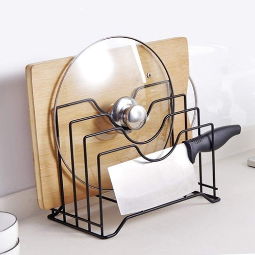 Black metal kitchen lid and cutting board organizer showcasing a wooden cutting board, a glass lid, and a knife.