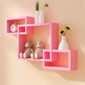 Bright pink modern wall shelf with geometric design, showcasing teddy bears, a clock, and decorative vases.