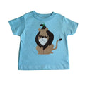 Light blue toddler T-shirt featuring an appliqué design of the Cowardly Lion with a playful expression and green accent.